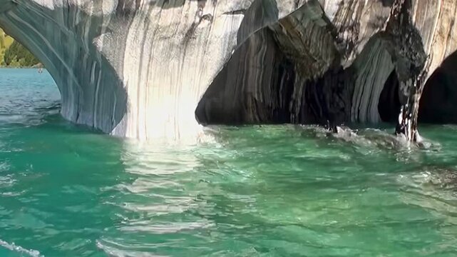 Experience breathtaking beauty of Marble Caves in Patagonia. Witness nature's artistry as pristine turquoise waters flow through ancient, sculpted marble formations, creating truly majestic wonder.