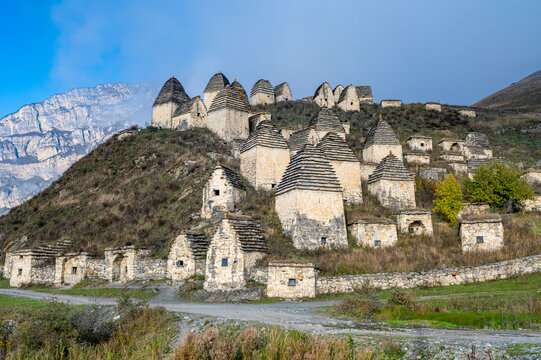 Historic structures stand on the hillside in Dargavs, showcasing ancient burial traditions found in North Ossetia, Russia