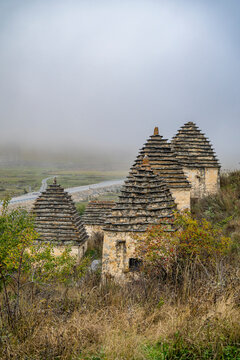 Exploration of historic structures in the city of the Dead in Dargavs, Caucasus region of North Ossetia, Russia