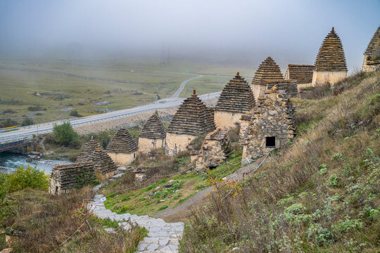 Exploring Dargavs ancient burial site in North Ossetia, Russia, surrounded by fog and mountains