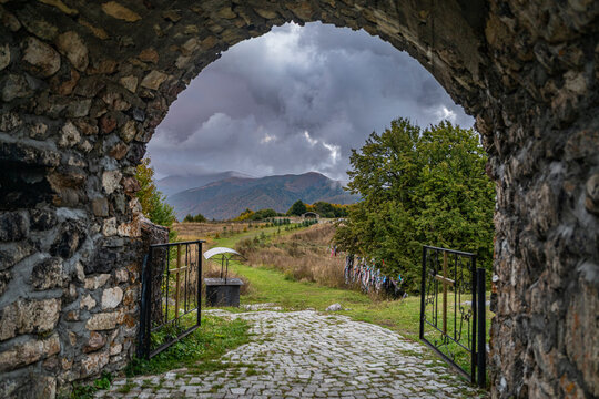 View of the entrance gate to St. George Church with landscape and mountains in Republic of South Ossetia