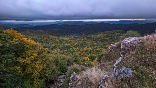 Overlook of mountains with changing colors from the St. George Church in South Ossetia during autumn