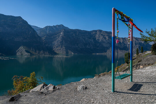 Swing over water in Dagestan with mountains surrounding the Awarskoje Koisu river in Russia