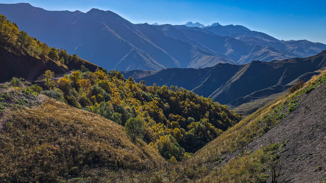 Remote mountain scenery showcases hilly terrain and natural landscapes in the Caucasus region of Russia during a clear day in Chechnya