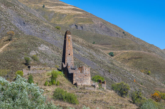 Old watchtower stands alone in the mountains of Chechnya as nature surrounds its ruins in the Caucasus region of Russia