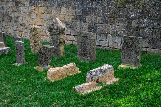 Grave markers stand in front of the ancient Naryn-Kala fortress in Dagestan, Russia highlighting its historical significance and heritage