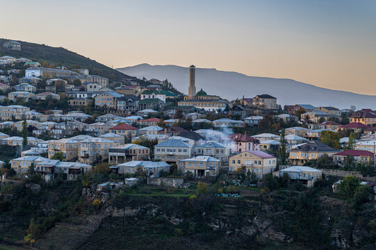 View over the buildings of Kubachi in Dagestan, Russia during evening light with distant mountains
