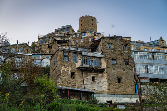 Old buildings stand tall in the center of a historic silver town in Dagestan, Russia with a tower overlooking the landscape