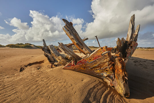 Disintegrating wreck rests on sand at Crow Point near Barnstaple in Devon, Great Britain