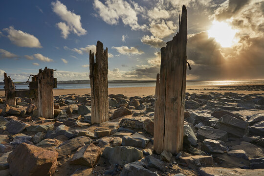 Groynes on the beach at Crow Point during sunset in Devon, Great Britain