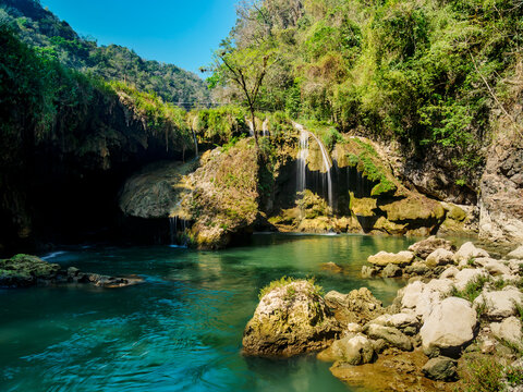 Cahabon River waterfalls flow into blue waters at Semuc Champey Natural Monument in Lanquin, Alta Verapaz, Guatemala