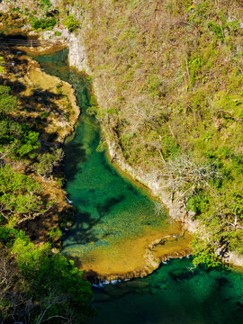 View of Semuc Champey Natural Monument from high ground in Lanquin, Alta Verapaz, Guatemala with clear water and green surroundings