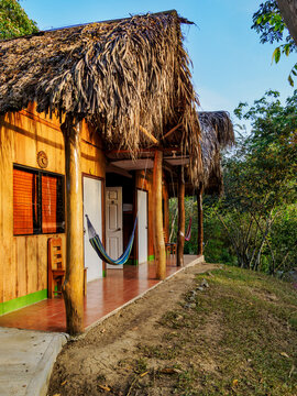 Visitors enjoy a unique stay in a wooden house with a thatched roof in Lanquin, Guatemala