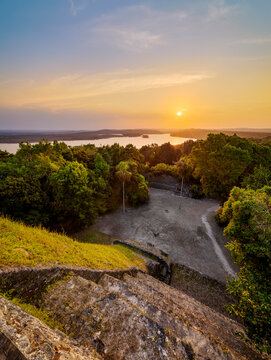 View from Temple 216 at East Acropolis during sunset with Yaxha Lake in the background in Guatemala