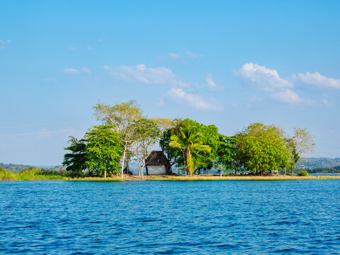 Islet in lake with trees and a small structure near Flores Island in Guatemala