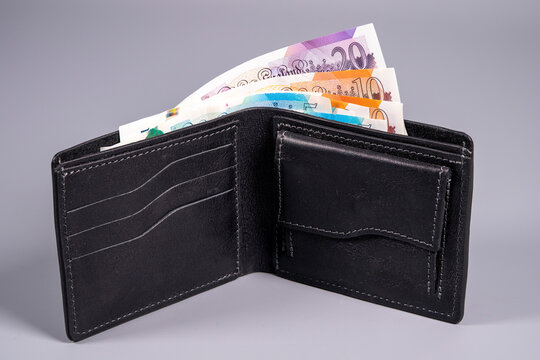 Wallet with British pound notes inside showing different denominations