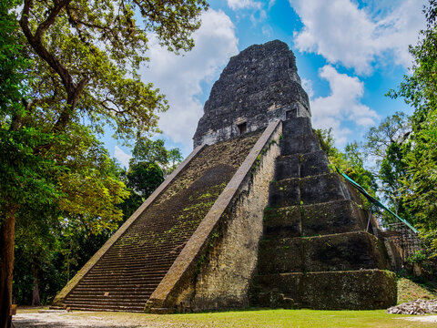 Exploring Temple V at Tikal reveals ancient Mayan architecture in Guatemala amidst nature