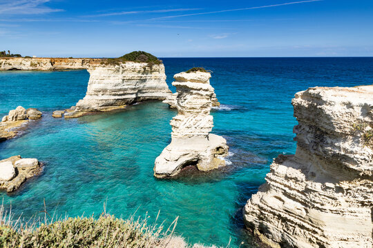 Explore faraglioni di Sant Andrea with clear blue waters and rocky formations in Salento Italy
