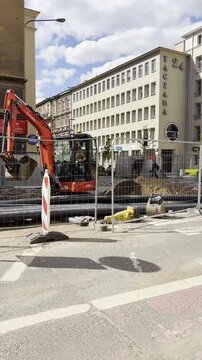 Poznan, Poland April 27, 2026 Construction Activity Ongoing. Excavator Working At Urban Site. Workers Operate Heavy Machinery In City Zone