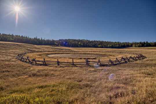 Sunset view of Deer Lake Sinkhole on the Kaibab Plateau with wooden fence to keep cattle safe