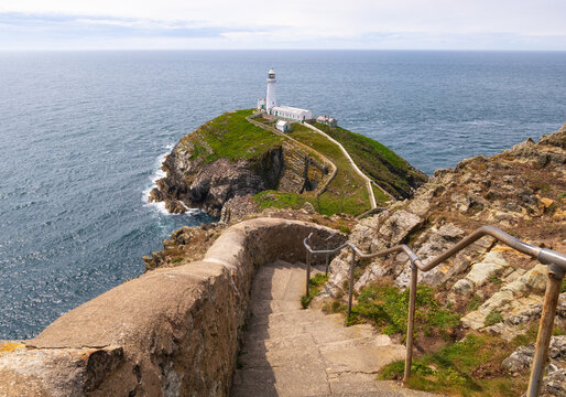 Stairs leading to South Stack Lighthouse with a view of the sea in Anglesey, Wales at a cloudy day