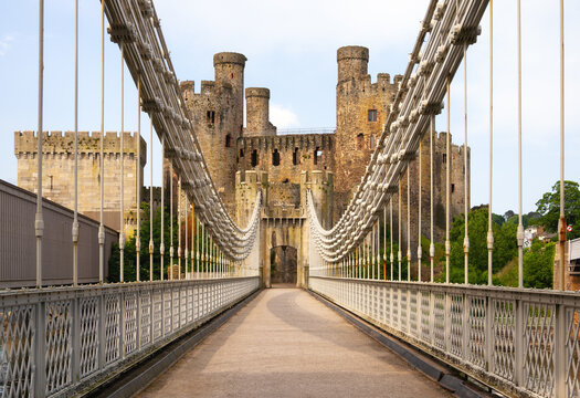 Conwy Suspension Bridge crosses River Conwy with Conwy Castle seen in the background in Wales