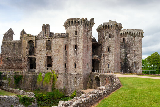 Explore the ruins of Raglan Castle with its towers and stone walls in a green landscape in Monmouthshire, Wales