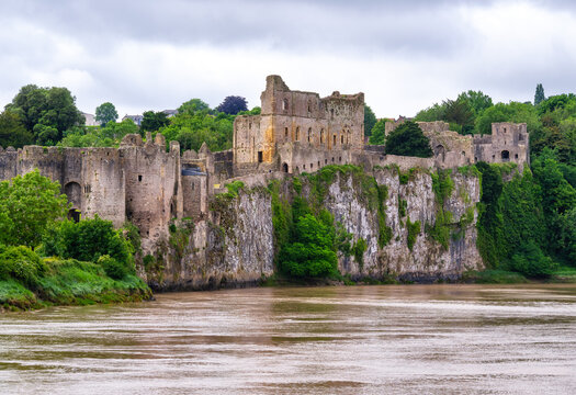 View of Chepstow Castle from the north bank of the River Wye in Monmouthshire Wales during overcast weather