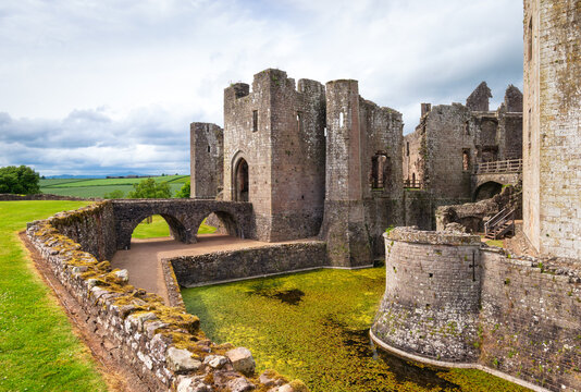 Explore Raglan Castle with its ancient stone walls and historic architecture surrounded by green landscape in Wales