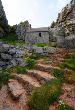 St Govans Chapel built into limestone cliff close to steep steps in Pembrokeshire, Wales