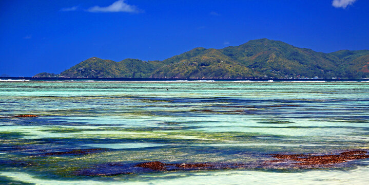 View of Praslin Island from Anse Source dArgent on La Digue in Seychelles during clear weather