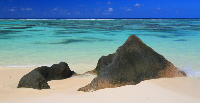 Visit Anse Source dArgent beach in La Digue Seychelles and enjoy the unique rock formations and clear water during a sunny day