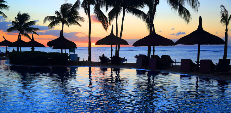 Sunset view from resort pool overlooking ocean at Pointe aux Piments Mauritius