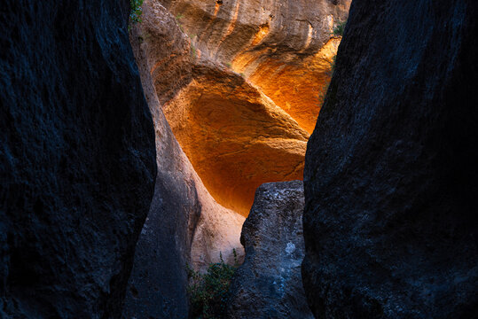 Reflections of orange light on sandstone walls in Barranco de Luna gorge in Spain create a unique visual experience for visitors