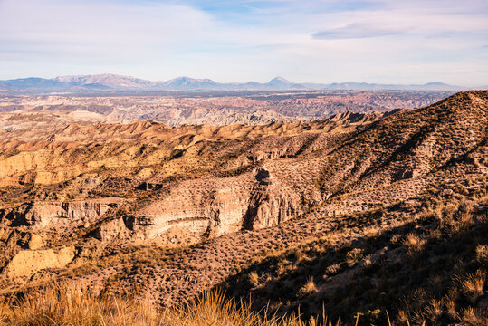 Sunlit ridges and valleys create patterns in the landscape of Desierto de Gorafe in southern Spain