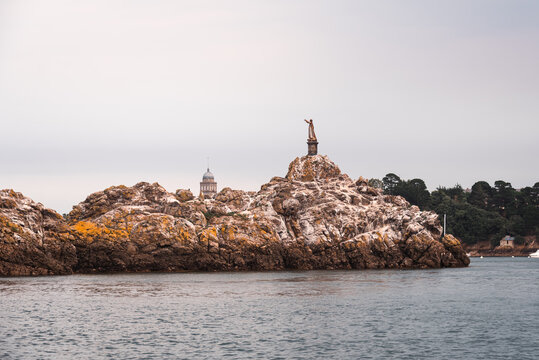 Virgin Mary statue on tidal rock in Brittany symbolizing maritime devotion in a local landmark