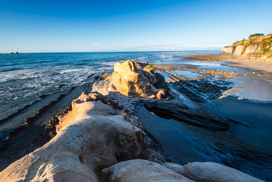 Coastal rock formations and sea at Cape Foulwind on the West Coast of South Island, New Zealand during daylight hours