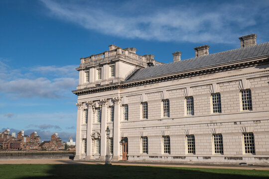 Historic Queen Anne Court Building viewed from an open area with clear skies in Greenwich London