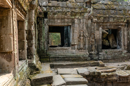 Exploring the ancient structures and carvings at Ta Prohm Temple in Cambodia near Siem Reap
