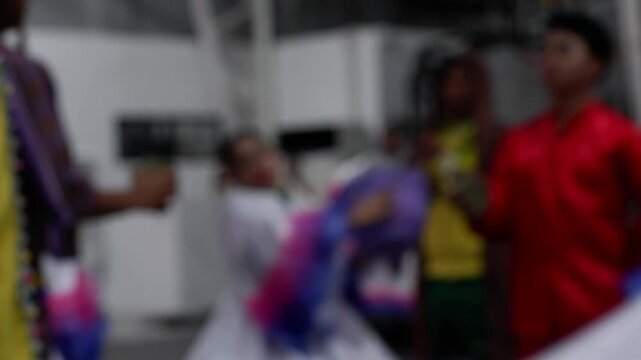Cultural dancers in traditional costumes from nearby towns perform their practiced dance steps at a government-sponsored trade fair held in the public grounds. Blurs