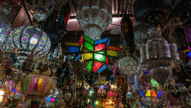 Colorful lanterns hang in the Souk of Marrakech during a busy market day in Morocco
