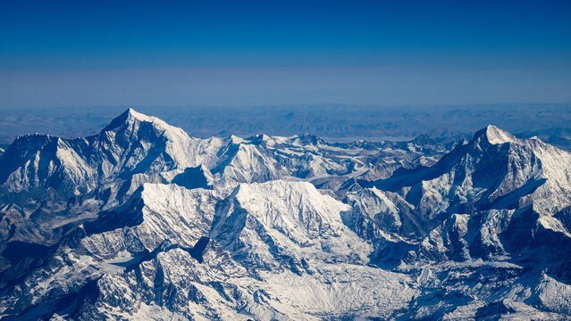 Himalaya mountain range seen from the air in Nepal showcasing snow and rock formations at high altitude