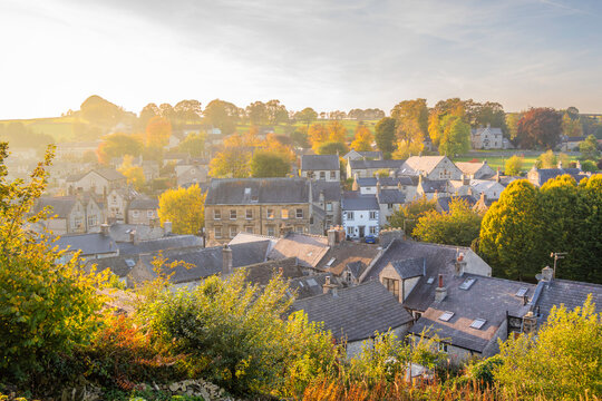 View of rooftops and trees in autumn in Tideswell, Derbyshire, during a sunny afternoon in the Peak District region
