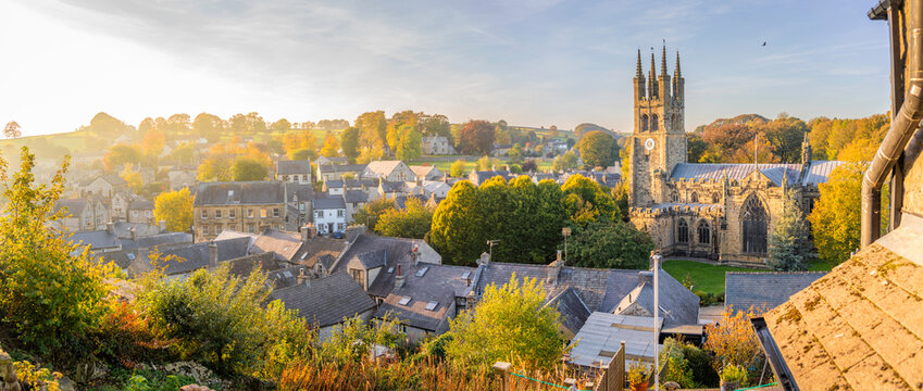 View of St John the Baptist Church surrounded by autumn colors in Tideswell, Derbyshire Peak District in England