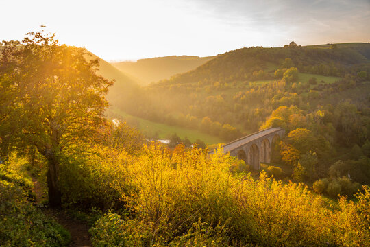 View of Monsal Dale and viaduct at sunset with autumn colors in Bakewell Derbyshire Dales England