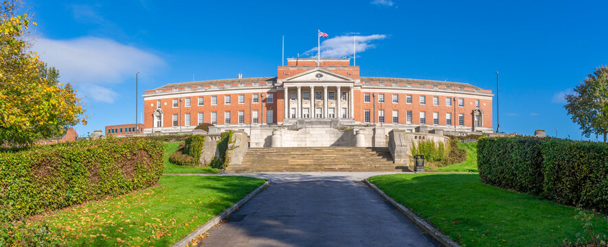 View of Chesterfield Town Hall in autumn with trees and walking path in Derbyshire, England, showing clear skies and structured landscape