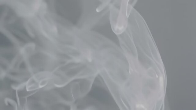 Abstract White Smoke Patterns Moving Against Gray Background.