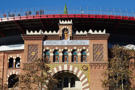 Arenas de Barcelona bullring building facade with arched windows and decorative tiles