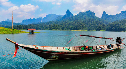 Fototapeta premium Traditional longtail boat on Cheow Lan Lake in Khao Sok National Park, Surat Thani, Thailand.