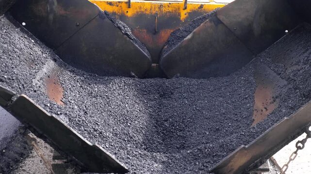 Fresh Asphalt Aggregate Inside Asphalt Paver Hopper Close Up
